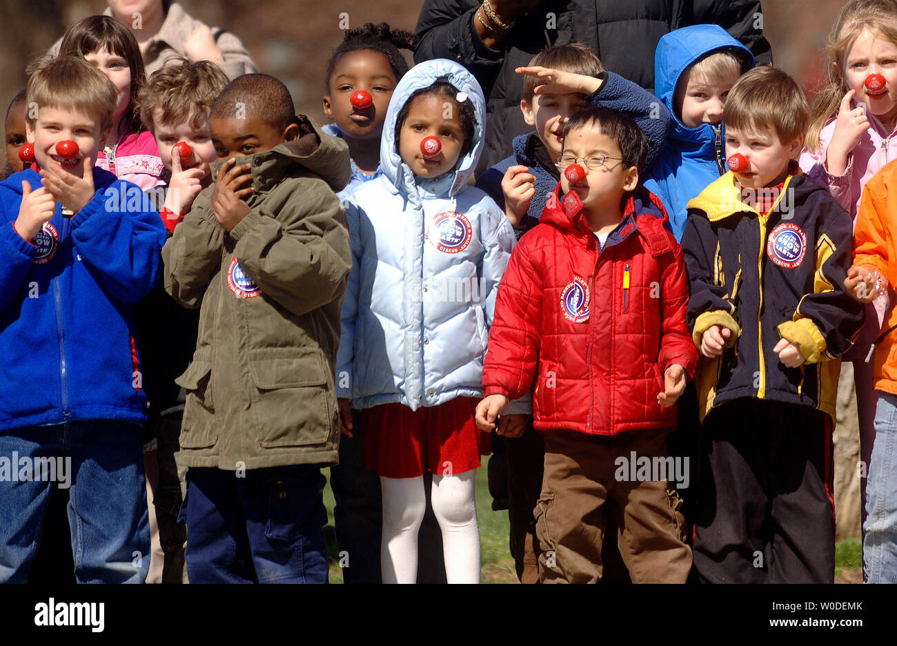 Children wearing red clown noses watch as the Ringling Brothers and Barnum Bailey Circus parade pass by, in Washington on March 19, 2007. The circus will be in the Washington area from March 22 to April 15. (UPI Photo/Kevin Dietsch) Stock Photo