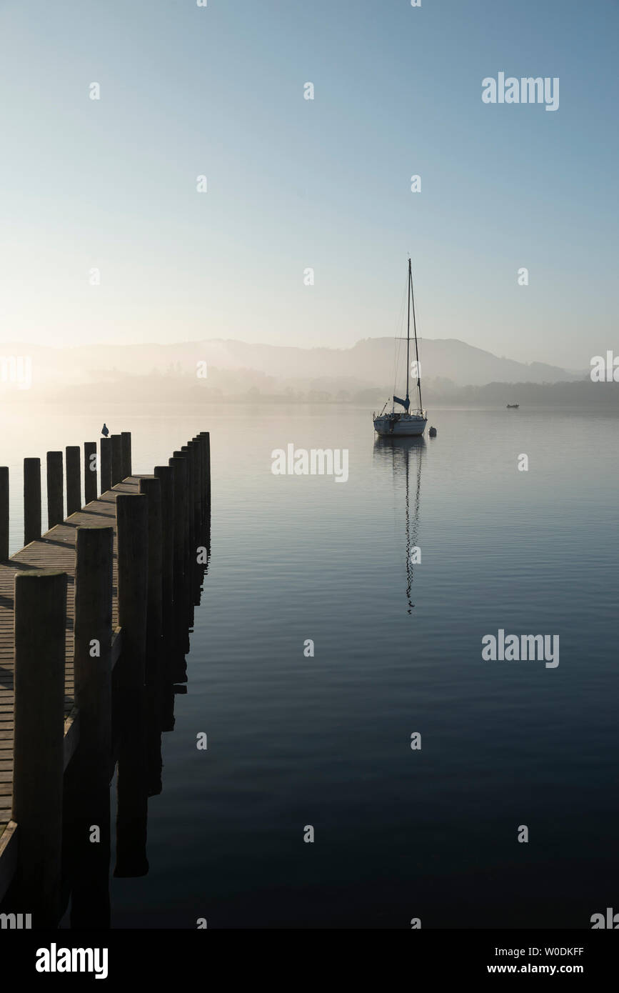 Beautiful unplugged landscape image of sailing yacht sitting still in