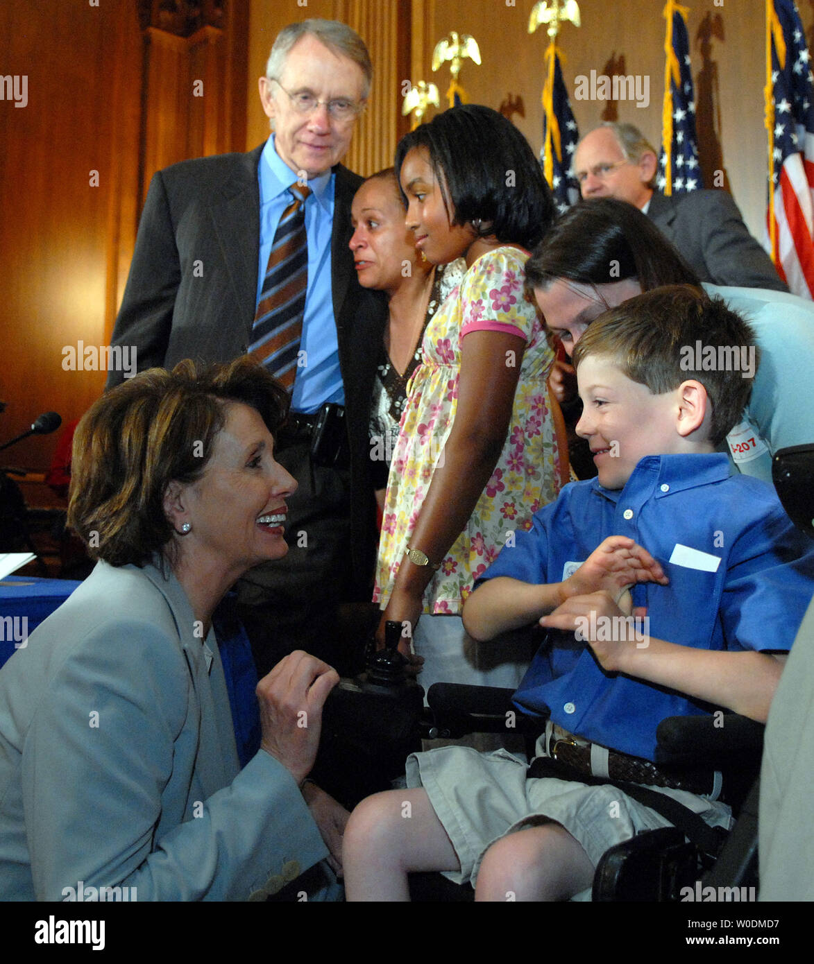Speaker of the House Nancy Pelosi, D-CA, greets wheel-chair-bound Alex  Pitts, age 6 1/2 of Nazareth, Pennsylvania, and his mother Melissa Pitts  prior to a ceremony to send the embryonic stem cell
