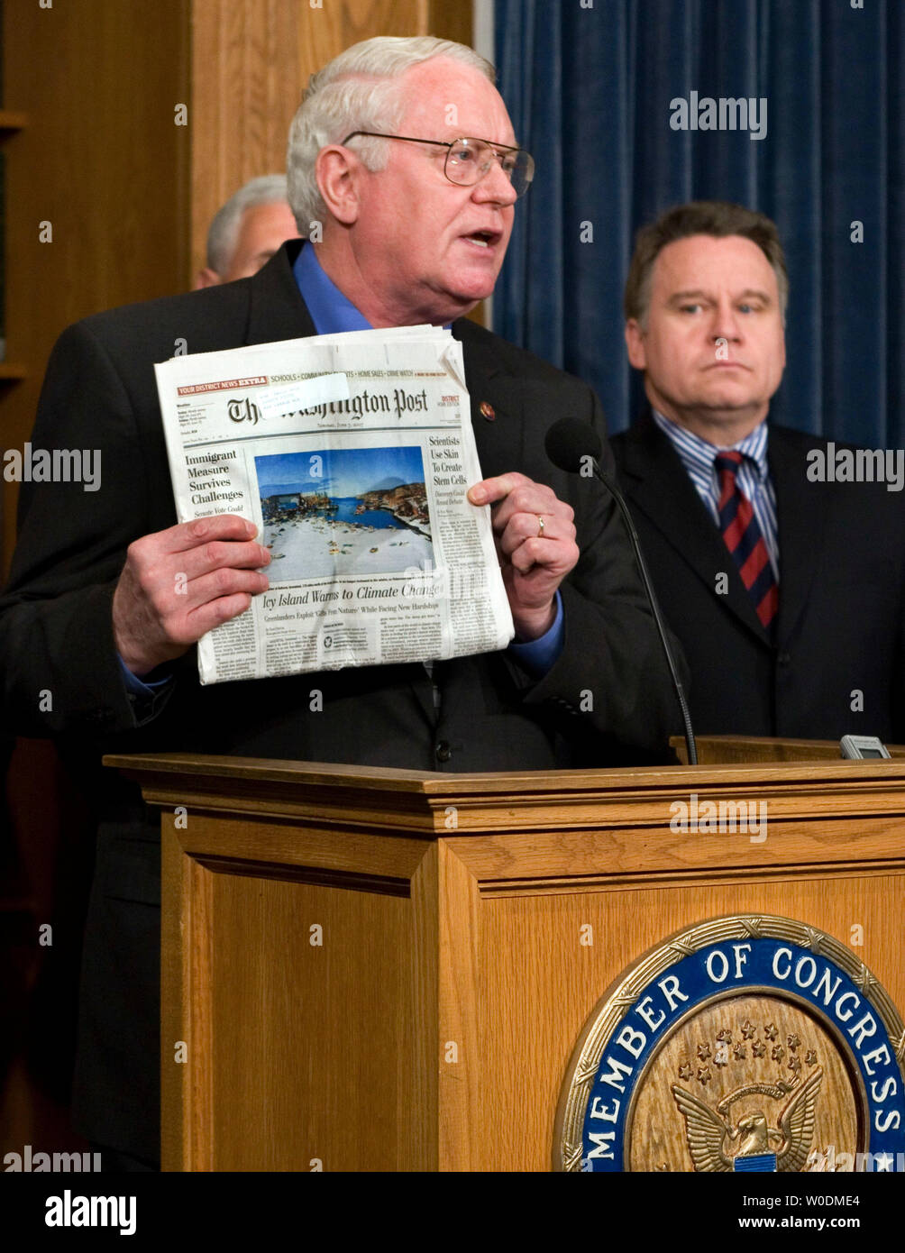 Rep. Joseph Pitts, R-PA, holds a 'Washington Post' newspaper with a headline regarding adult stem cell research, as Rep. Chris Smith, R-NJ, looks on, during a news conference on Capitol Hill in Washington on June 7, 2007. The Republicans say they have enough votes to sustain a Presidential veto of a bill recently passed by Congress that funds embryonic stem cell research. (UPI Photo/Roger L. Wollenberg) Stock Photo
