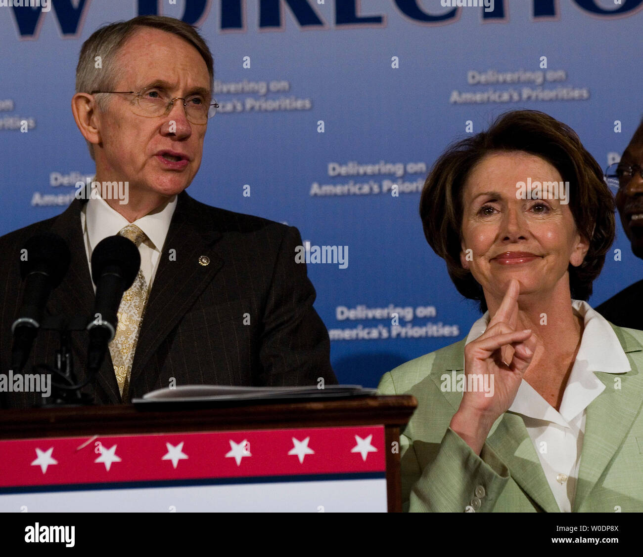 Speaker of the House Nancy Pelosi (D-CA) listens as Senate Majority Leader Harry Reid (D-NV) discusses the legislative accomplishments of and obstacles to the new Democratic Congress over the past six months on Capitol Hill in Washington on June 29, 2007.     (UPI Photo/David Brody) Stock Photo