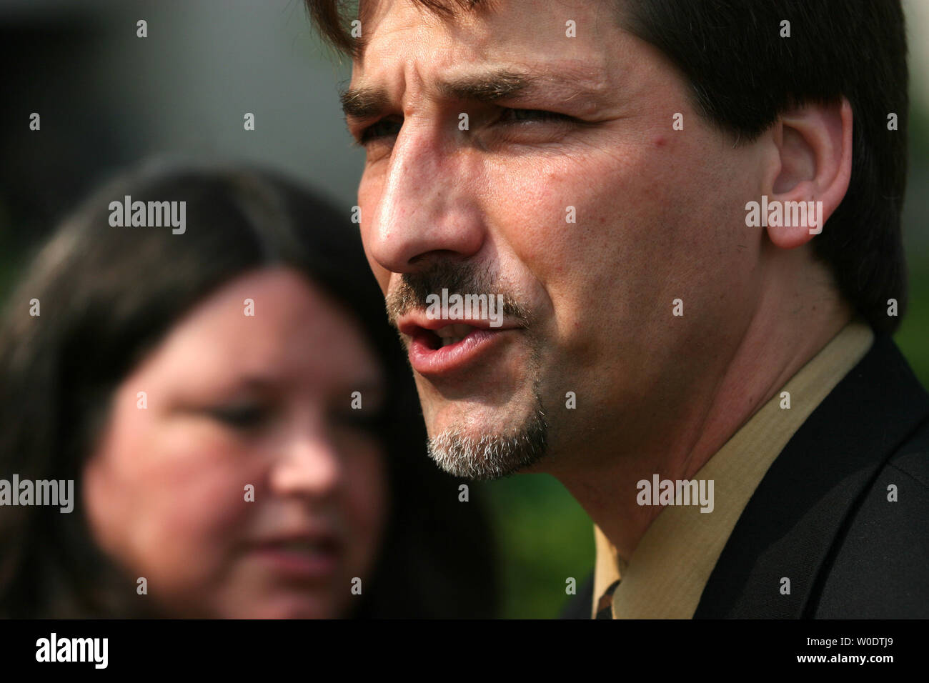 Ante Pavkovic (R) and his wife Kathy Pavkovic (L) participate in a