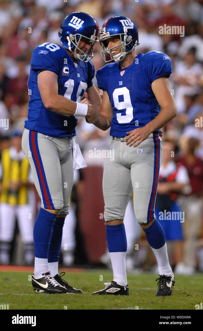 New York Giants kickers Lawrence Tynes (9) is congratulated by spotter Jeff  Feagles after making a point against the Washington Redskins during the  fourth quarter at FedEx Field on September 23, 2007.