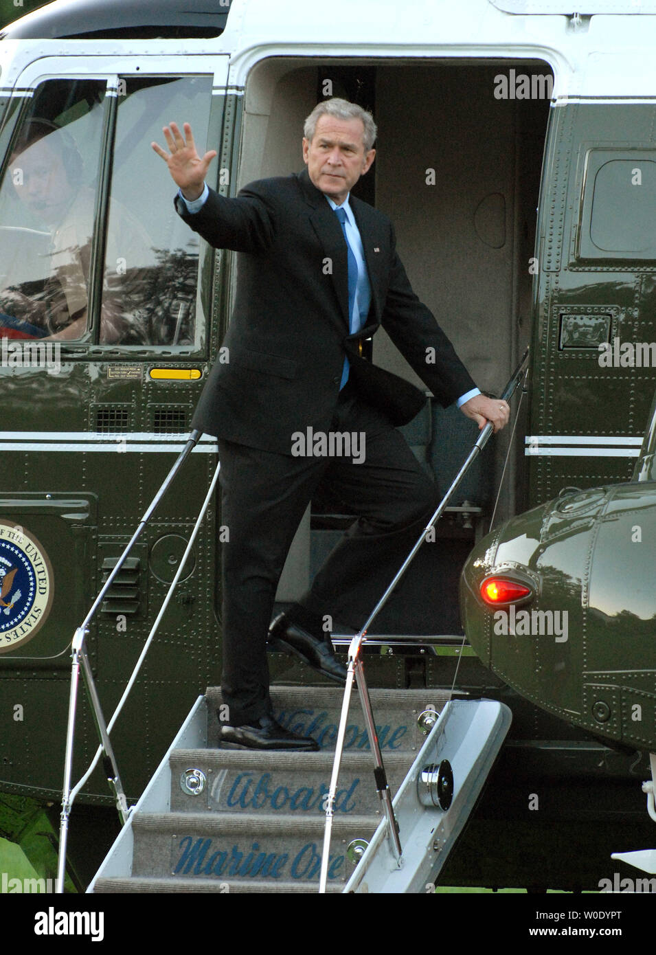 U.S. President George W. Bush waves as he departs from the South Lawn ...