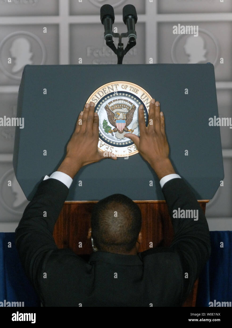 A secret service officer adjusts the presidential seal on the podium before U.S. President George W. Bush speaks at the Federalist Society Gala at Union Station in Washington on November 15, 2007. (UPI Photo/Alexis C. Glenn) Stock Photo