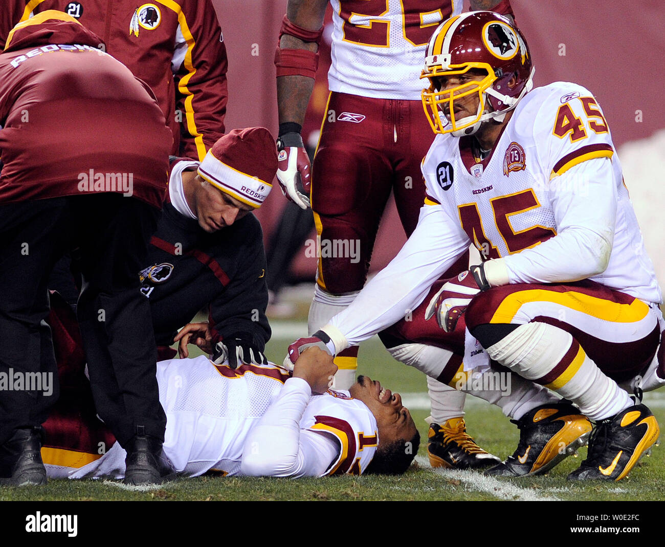 Washington Redskins quarterback Jason Campbell is attended to by fullback Mike Sellers and Redskins trainers after dislocating his left patella tendon in the second quarter against the Chicago Bears at FedEx Field in Landover, Maryland, on December 6, 2007.   (UPI Photo/Roger L. Wollenberg) Stock Photo