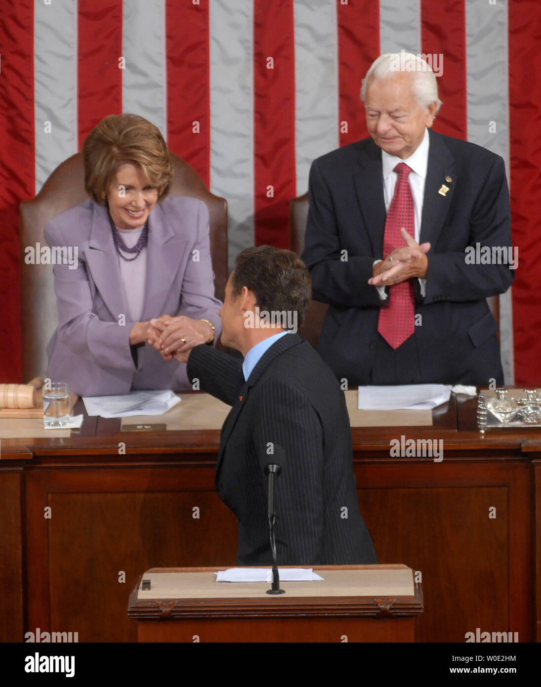 French President Nicolas Sarkozy shakes hands with Speaker of the House Nancy Pelosi while Senate President Pro Tempore Robert Byrd (D-WV) watches on following his address to a joint meeting of Congress at the Capitol Building in Washington on November 7, 2007. (UPI Photo/Kevin Dietsch) Stock Photo