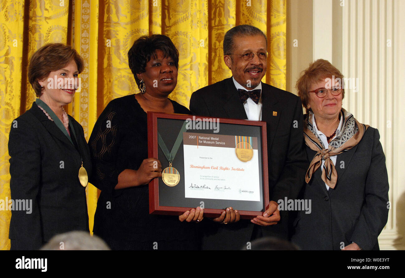 First Lady Laura Bush (L) and Dr. Anne-Imelda Radice, Institute of Museum and Library Services (IMLS) director, (R) present the Birmingham Civil Rights Institute President and CEO Lawrence Pijeaux, Jr. and community representative Shirina Davenport with a 2007 National Medal for Museum and Library Service during a ceremony in the East Room of the White House in Washington on January 14, 2008. (UPI Photo/Roger L. Wollenberg) Stock Photo
