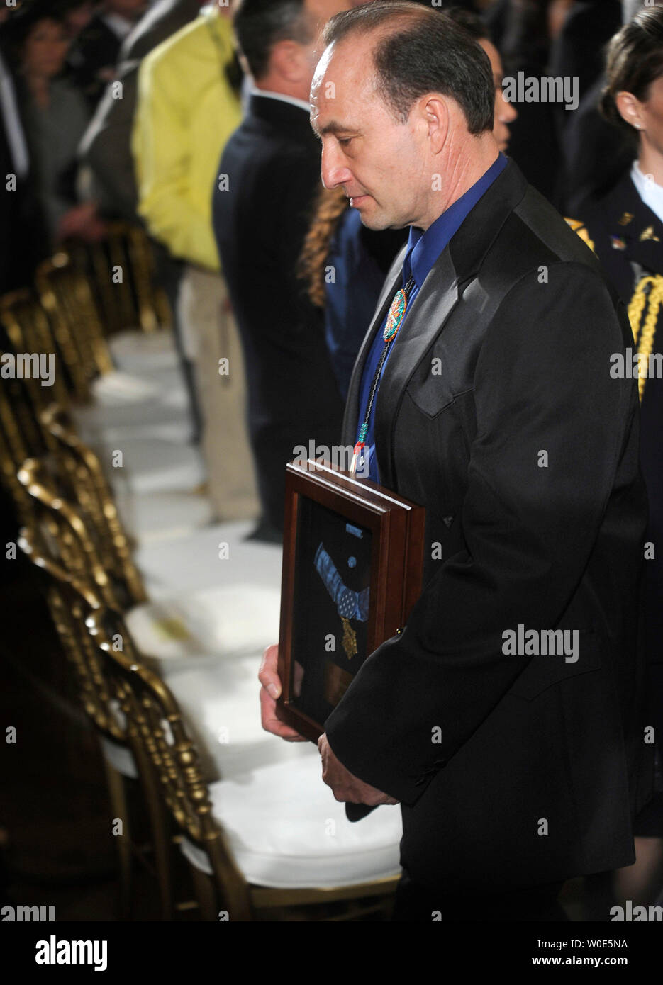 Russ Hawkins, stepson of Master Sgt. Woodrow Wilson Keeble, walks out