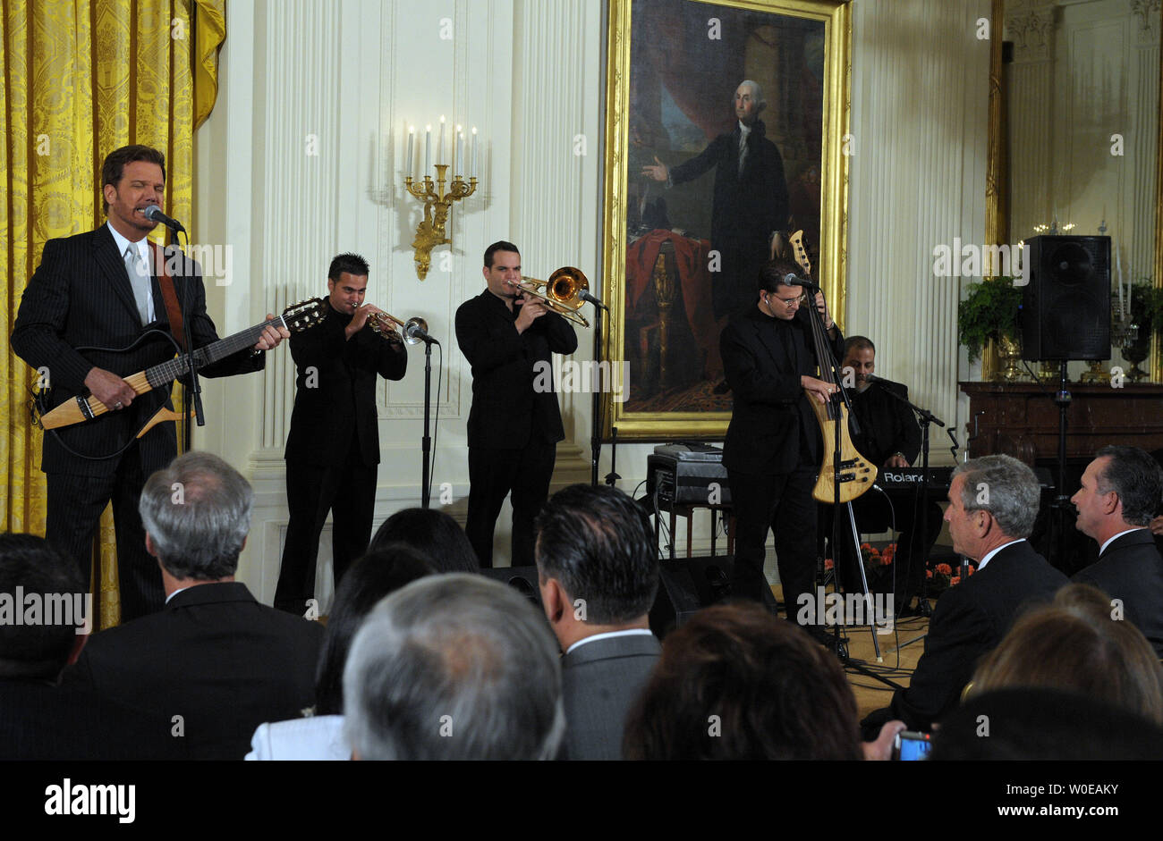 U.S. President George W. Bush listens to Willy Chirino perform after Bush called for more freedom and democracy in Cuba during a event to express solidarity with Cubans in the East Room of the White House on May 21, 2008.   (UPI Photo/Roger L. Wollenberg) Stock Photo