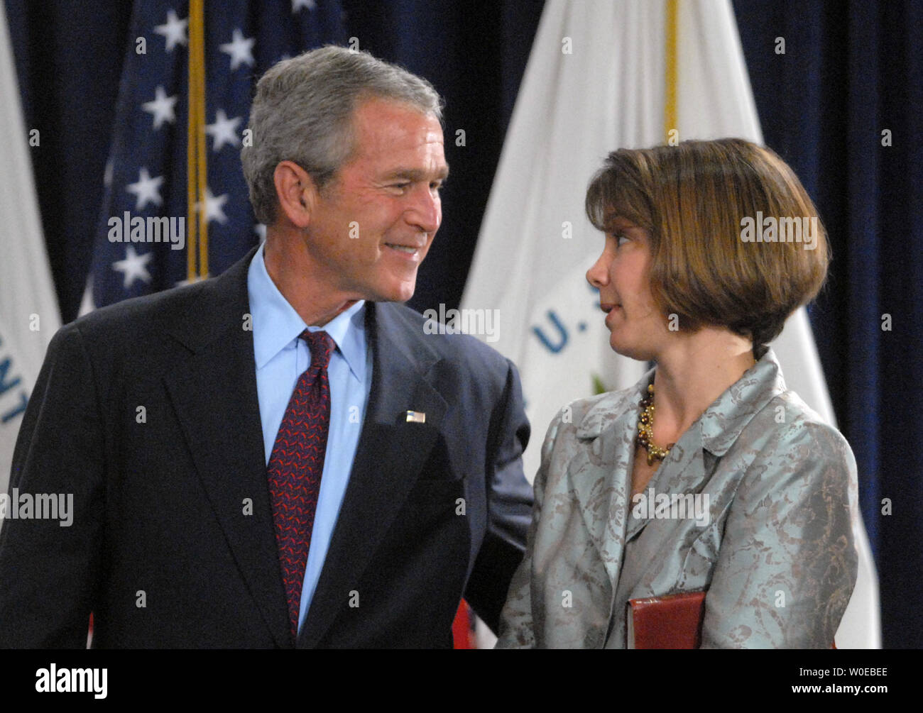 u-s-president-george-w-bush-speaks-to-molly-preston-wife-of-steven-preston-new-director-of-u-s-department-of-housing-and-urban-development-during-preston-s-swearing-in-ceremony-in-washington-on-june