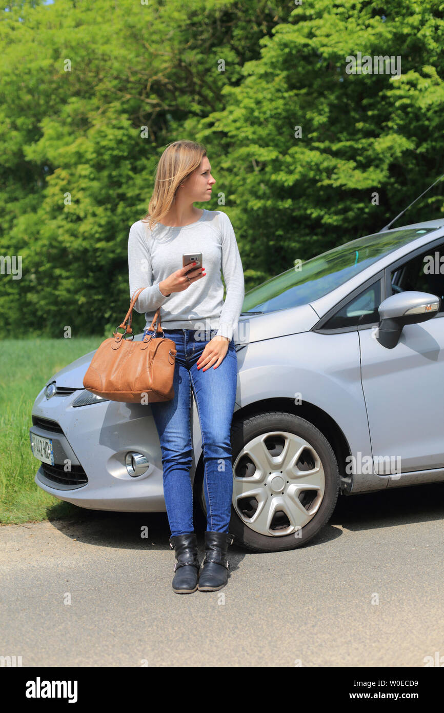 Young woman waiting on is car Stock Photo