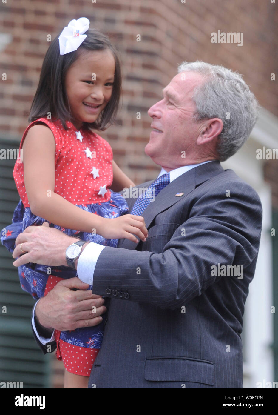 U.S. President George W. Bush holds newly naturalized United States citizen, Julie White Freeman, during an Independence Day naturalization ceremony at Monticello, the home of Thomas Jefferson, in  Charlottesville, Virginia on July 4, 2008. 72 foreign nationals were sworn-in as United States citizens. (UPI Photo/Kevin Dietsch) Stock Photo