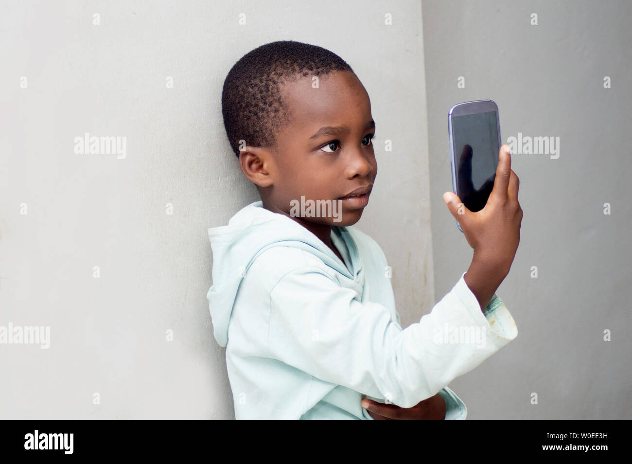 Little boy takes  a picture with his phone . Stock Photo