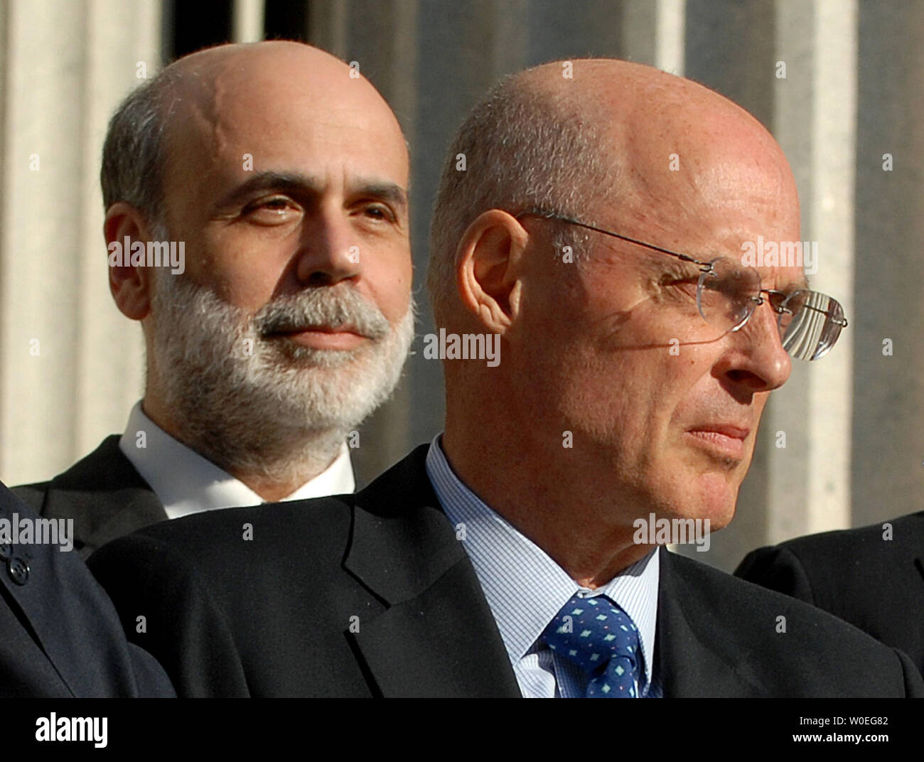 U.S.Treasury Secretary Henry Paulson (R) walks in front of U.S. Federal Reserve Board Chairman Ben Bernanke during a photo session with the Group of Seven finance ministers and central bank governors on the steps of the Treasury Department in Washington on October 10, 2008. The world ministers pledged decisive action to deal with the worst the global financial crisis since the Great Depression.   (UPI Photo/Roger L. Wollenberg) Stock Photo