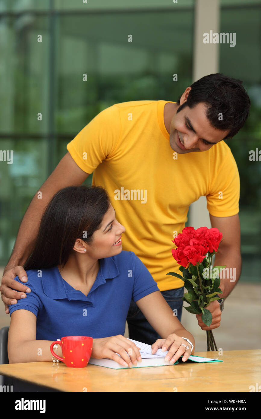 Boy giving flowers to a girl Stock Photo Alamy