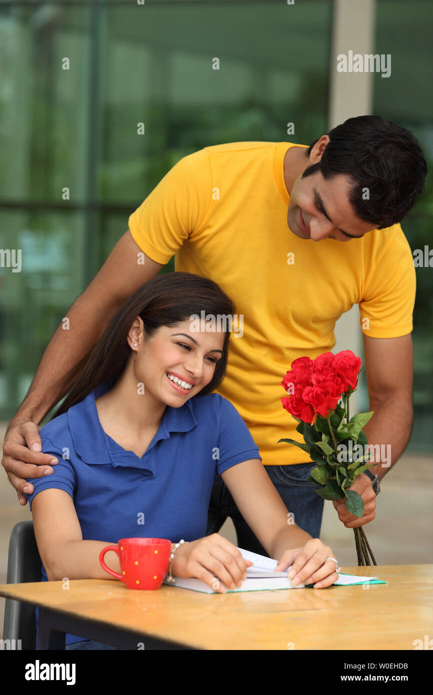 Boy giving flowers to a girl Stock Photo Alamy