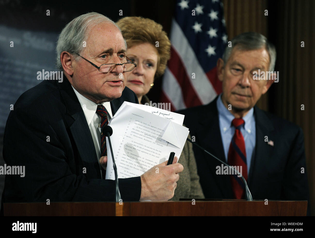 Sen. Carl Levin, D-MI, backed by Sen. Debbie Stabenow, D-MI, and Sen. George Voinovich, R-OH, speaks to the media about his proposed bailout options for automakers Ford, GM and Chrysler, on Capitol Hill in Washington on November 20, 2008. Senate and House leaders are delaying action, pending receipt of reform plans from the auto industry, and plan to return to the issue in early December. Levin argued that his plan might be able to pass if brought immediately to the floor, but it is unlikely the Senate will take up the matter again today.  (UPI Photo/Roger L. Wollenberg) Stock Photo