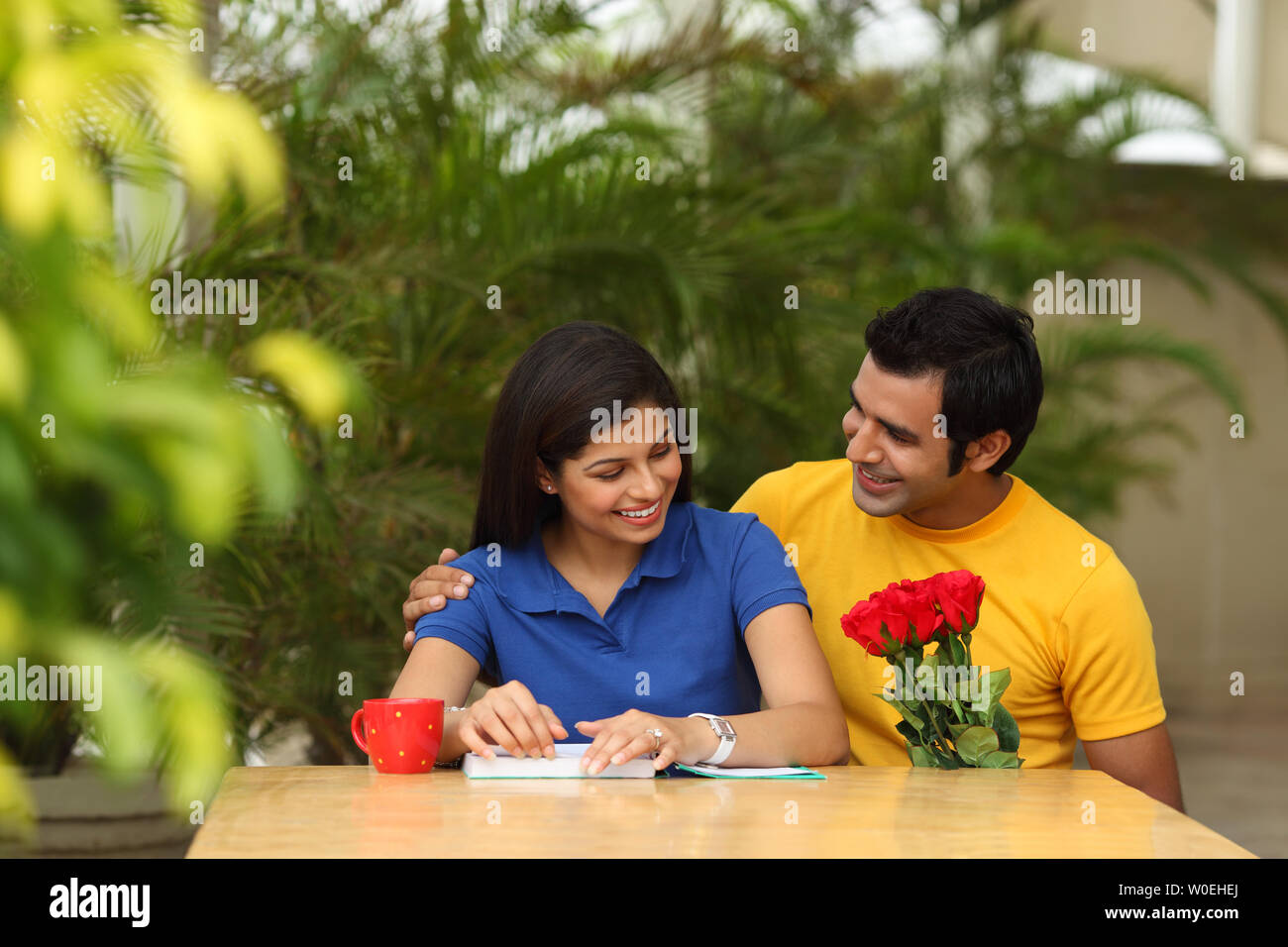 Boy giving flowers to a girl Stock Photo Alamy