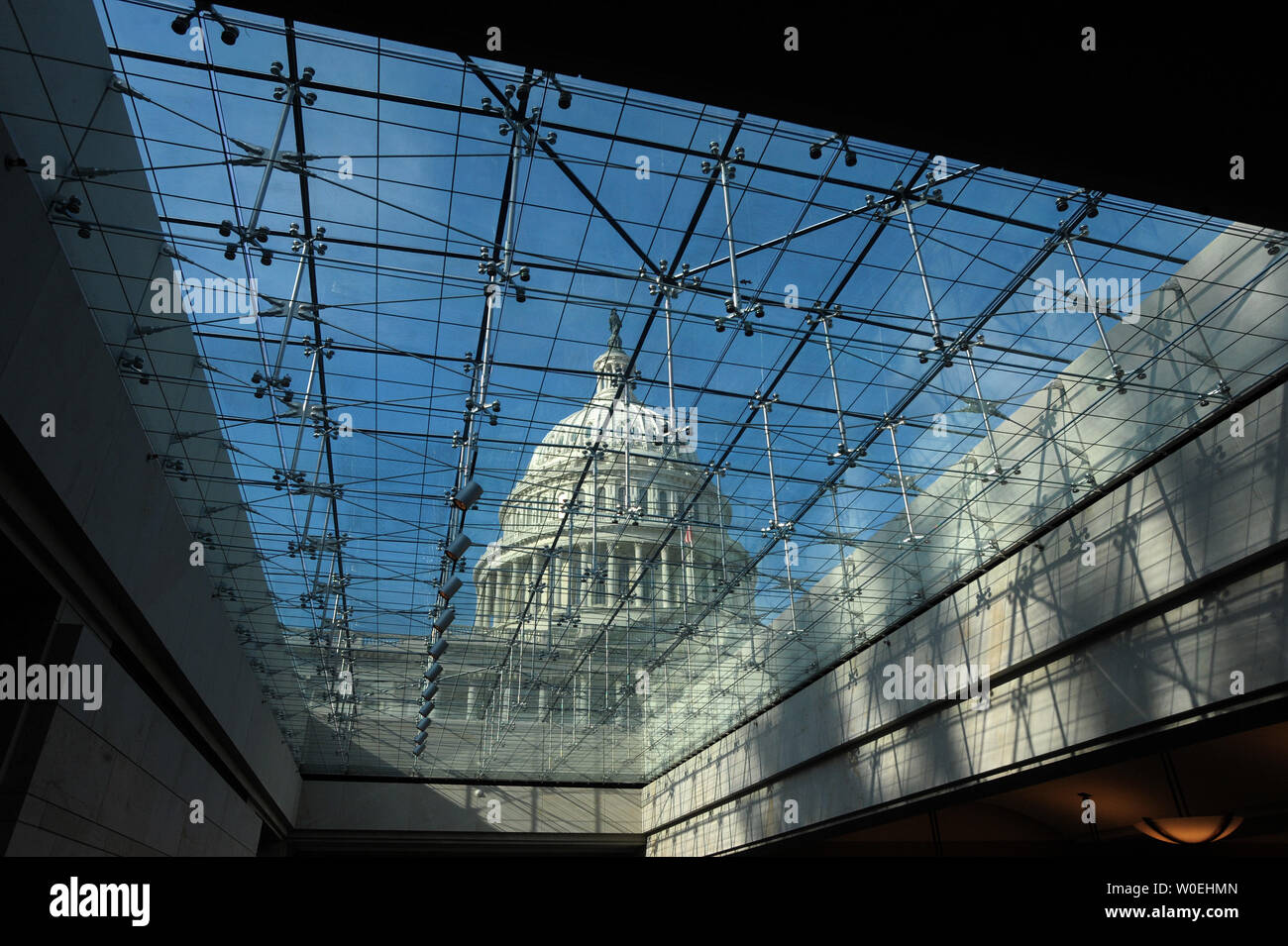 A View Of The Capitol Dome Is Seen Through A Glass Ceiling