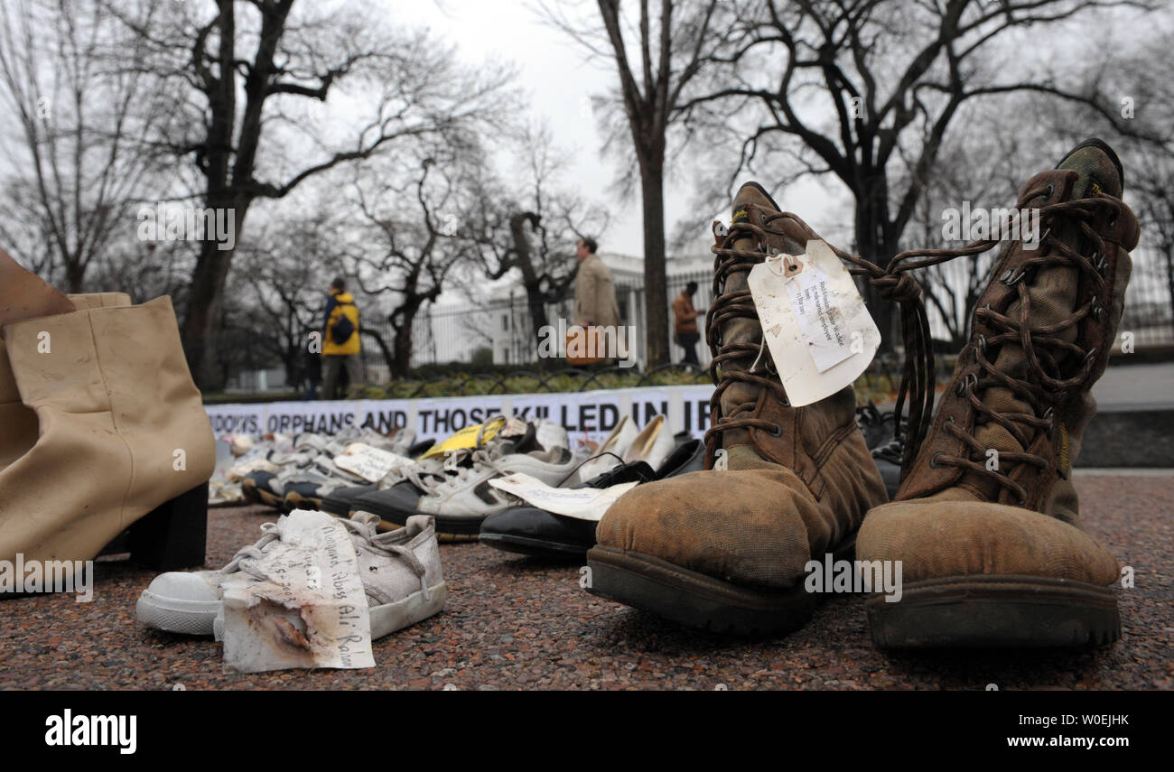 Shoes representing Iraqi dead are displayed in solidarity with the Iraqi journalist who threw his shoes at U.S. President George W. Bush and with the tens of thousands of Iraqis killed in the war, some of whose names are attached to the shoes, during a peace protest near the White House in Washington on December 17, 2008.   (UPI Photo/Roger L. Wollenberg) Stock Photo
