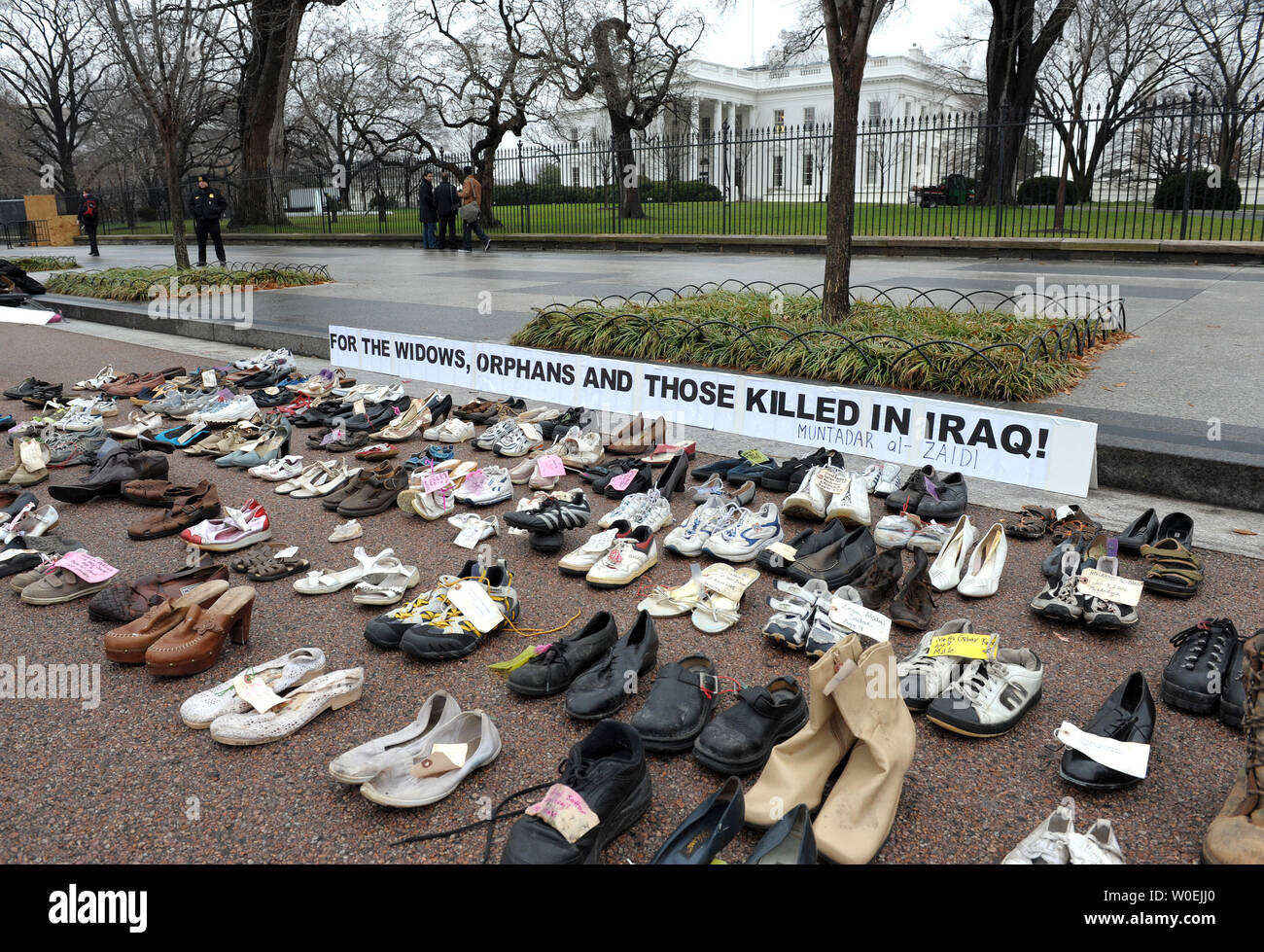 Shoes representing Iraqi dead are displayed in solidarity with the Iraqi journalist who threw his shoes at U.S. President George W. Bush and with the tens of thousands of Iraqis killed in the war, some of whose names are attached to the shoes, during a peace protest near the White House in Washington on December 17, 2008.   (UPI Photo/Roger L. Wollenberg) Stock Photo