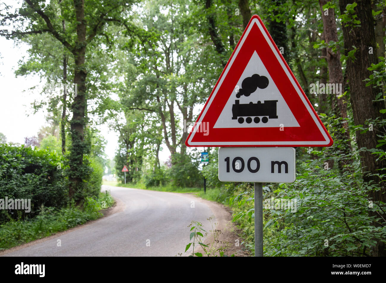 Dutch warning road sign with train meaning level crossing without barrier  or gates ahead Stock Photo - Alamy