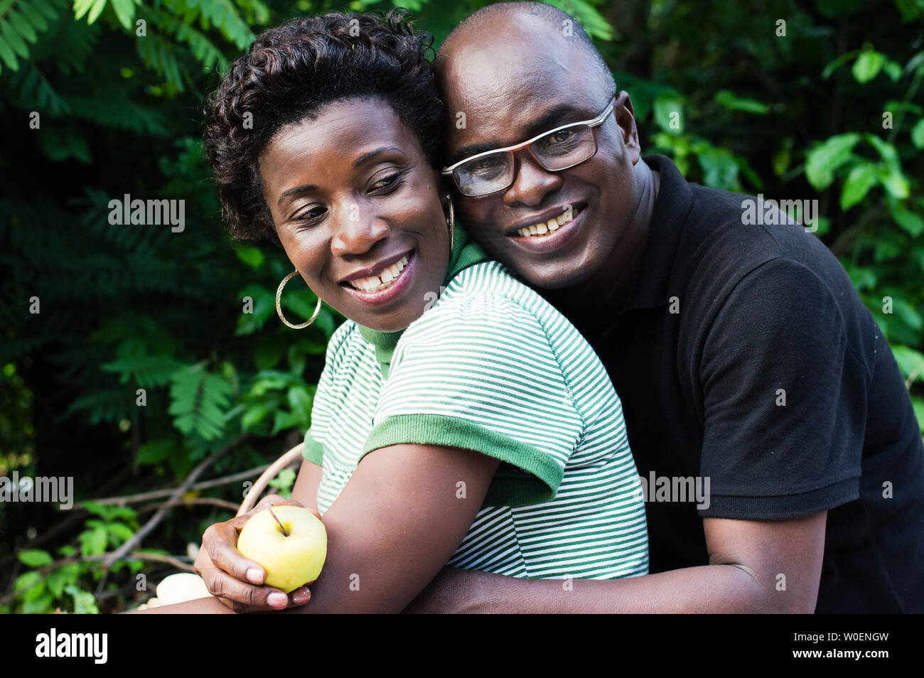 happy young couple hugging sitting in the bush picnic Stock Photo