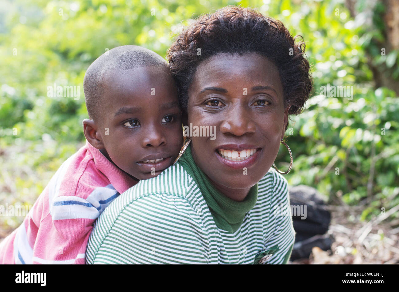 this happy mother carries her son on back Stock Photo