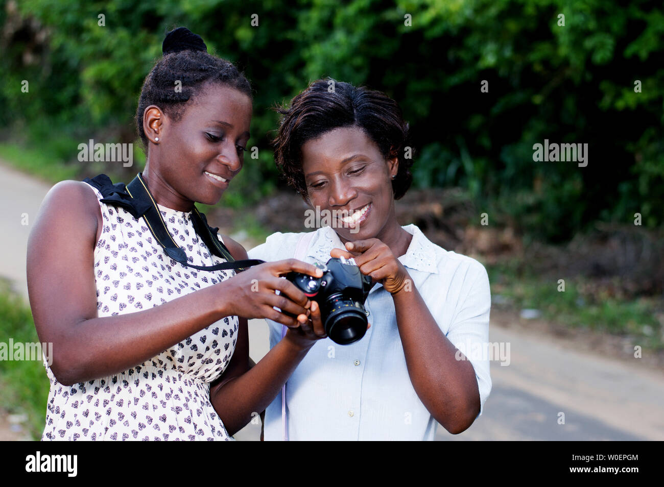 Young photographer showing  her  girlfriend the beautiful pictures she took her Stock Photo