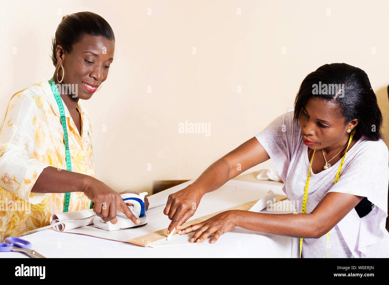 seamstress teaches her students to draw before carving. Stock Photo