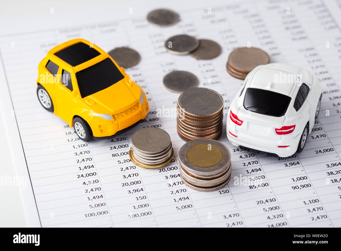 Cars and coins on financial statement, buying, trading, leasing Stock Photo