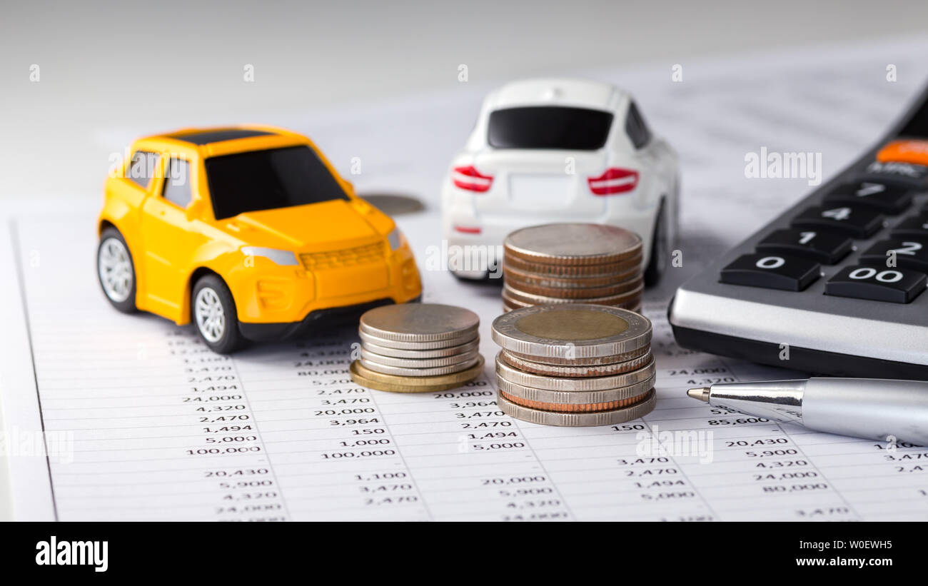 Coins, cars with calculator on financial statement, buying, trading, leasing Stock Photo