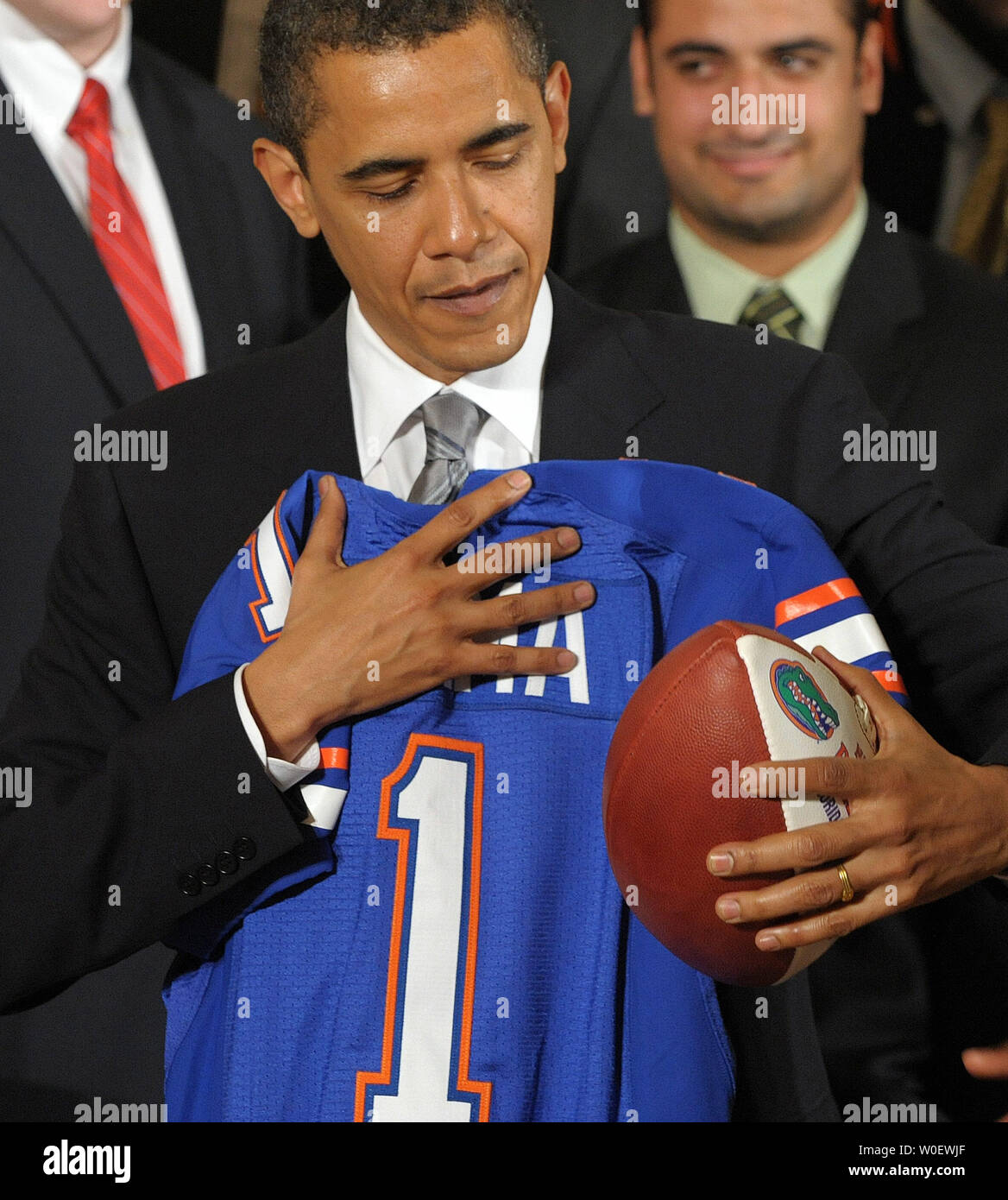 U.S. President Barack Obama stands with the jersey and football presented to him by the University of Florida Gators football team, whom he congratulated on winning the 2009 BCS National Championship, in the East Room of the White House in Washington on April 23, 2009.    (UPI Photo/Roger L. Wollenberg) Stock Photo