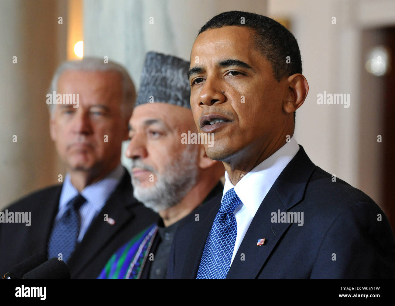 U.S. President Barack Obama (R) delivers remarks alongside Afghanistan President Hamid Karzai (C) and Vice President Joe Biden following a meeting with Karzai and Pakistan President Asif Ali Zardari (not pictured), in the Grad Foyer at the White House in Washington on May 6, 2009. (UPI Photo/Kevin Dietsch) Stock Photo