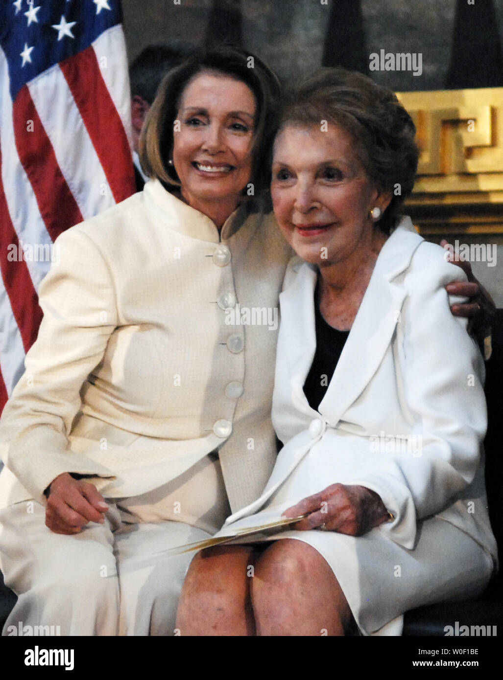Speaker of the House Nancy Pelosi (D-CA) (L) hugs former First Lady Nancy Reagan at an unveiling ceremony for a statue of former U.S. President Ronald Reagan in the Rotunda of the U.S. Capitol building in Washington on June 3, 2009. The statue will become part of the National Statuary Hall Collection. (UPI Photo/Alexis C. Glenn) Stock Photo