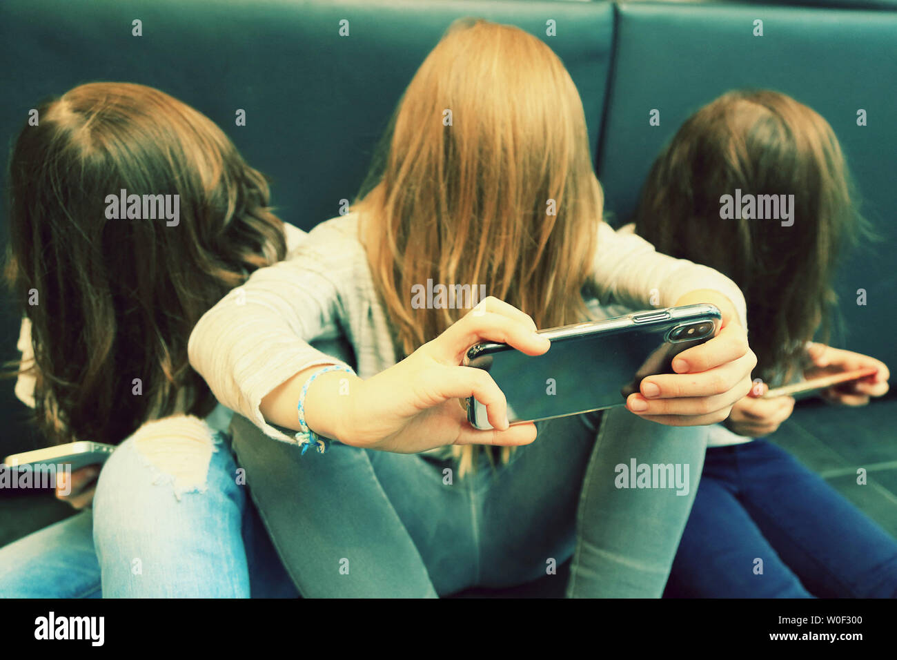 3 girls with smartphone Stock Photo