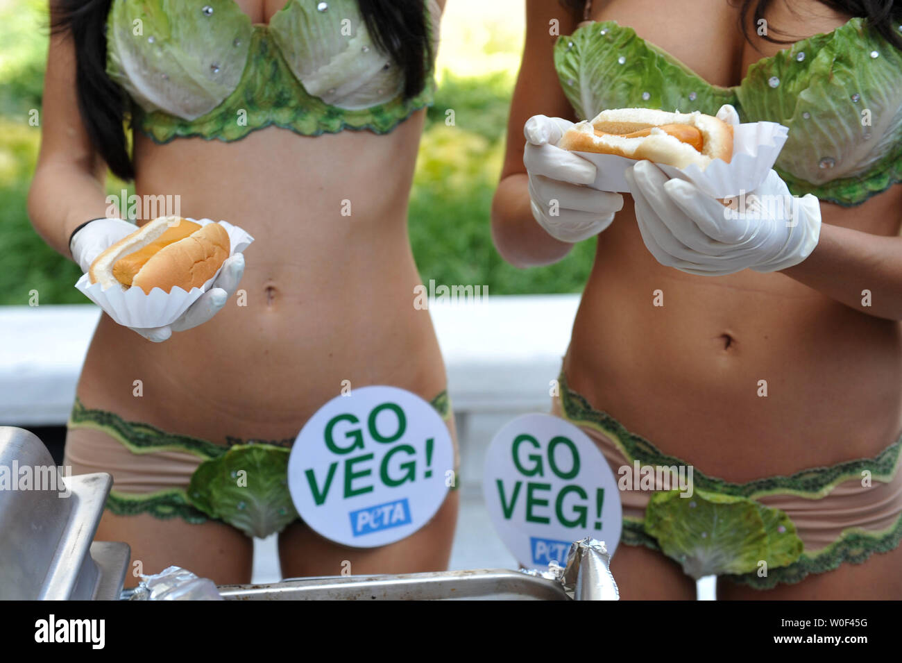 Playboy Playmate of the Year Jayde Nicole (L) and Playmate Joe Garcia (C) serve veggie hot dogs as part of an event put on by People for the Ethical Treatment of Animals (PETA) to call out against National Hot Dog Month, on Capitol Hill in Washington on July 15, 2009. (UPI Photo/Kevin Dietsch) Stock Photo