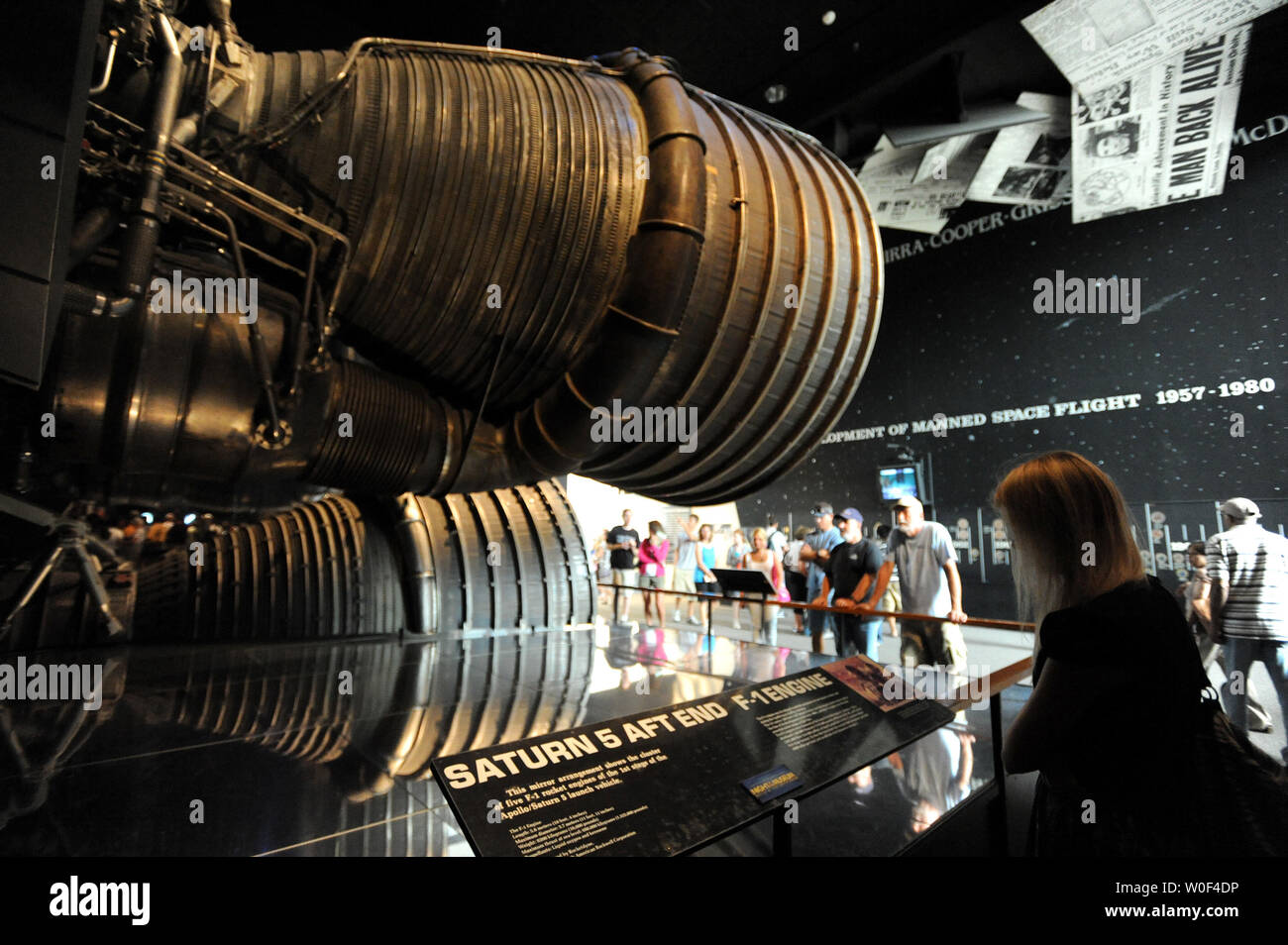 Tourists look at the giant aft burners of the Saturn V rocket at the Smithsonian Air and Space Museum's 'Apollo to the Moon' exhibit on July 20, 2009 in Washington, DC.  Five giant first-stage engines propelled the Saturn V and Apollo missions into space.   Today is the 40th anniversary of astronaut Neil Armstrong's first walk on the moon via Apollo 11, on July 20, 1969.  The Apollo 11 crew was Armstrong, Buzz Aldrin and Michael Collins.   (UPI Photo/Pat Benic) Stock Photo