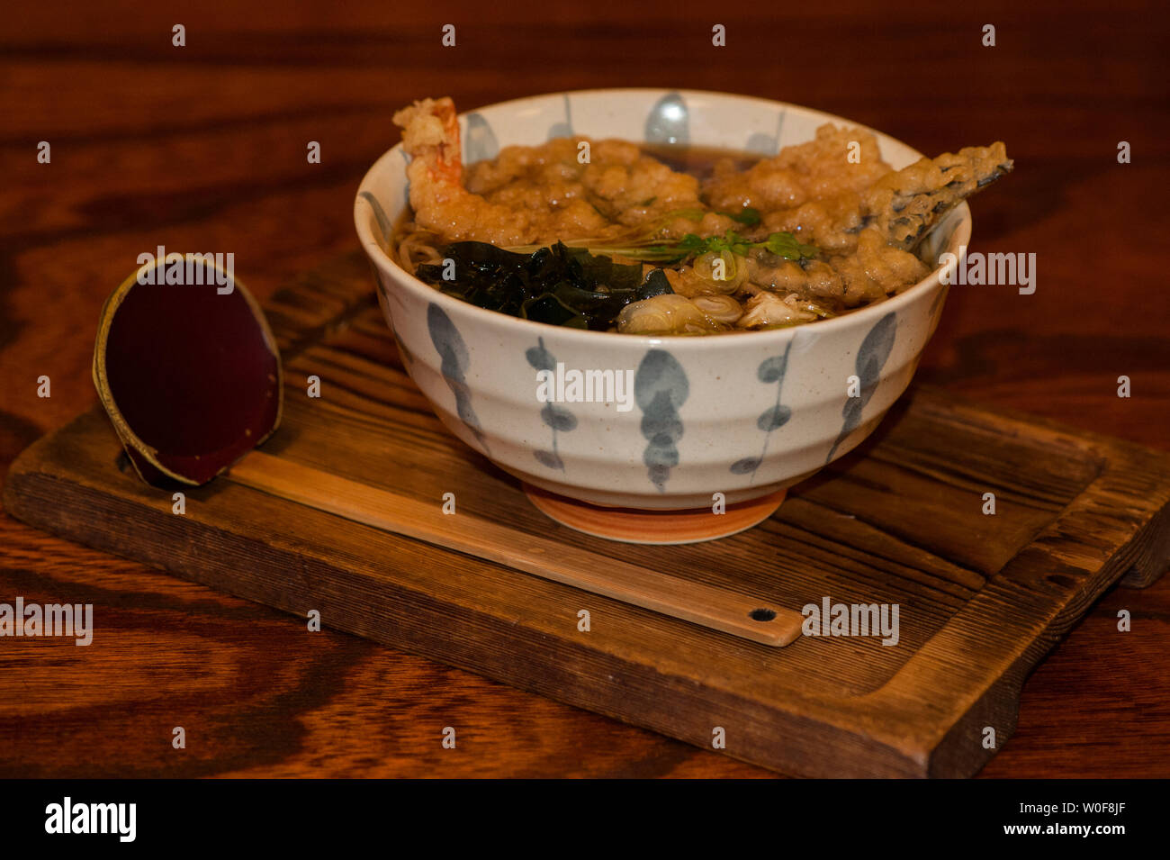 Udon tempura dish in a bowl upon a wood made chopping board, Kawaguchiko, Japan Stock Photo