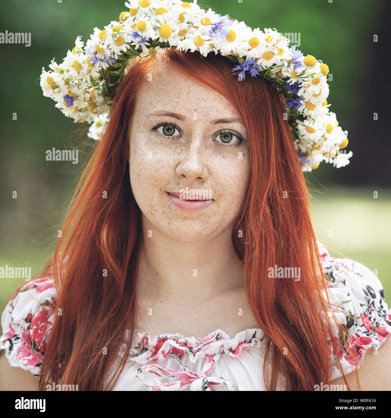 Portrait of a red-haired freckled woman in a wreath Stock Photo