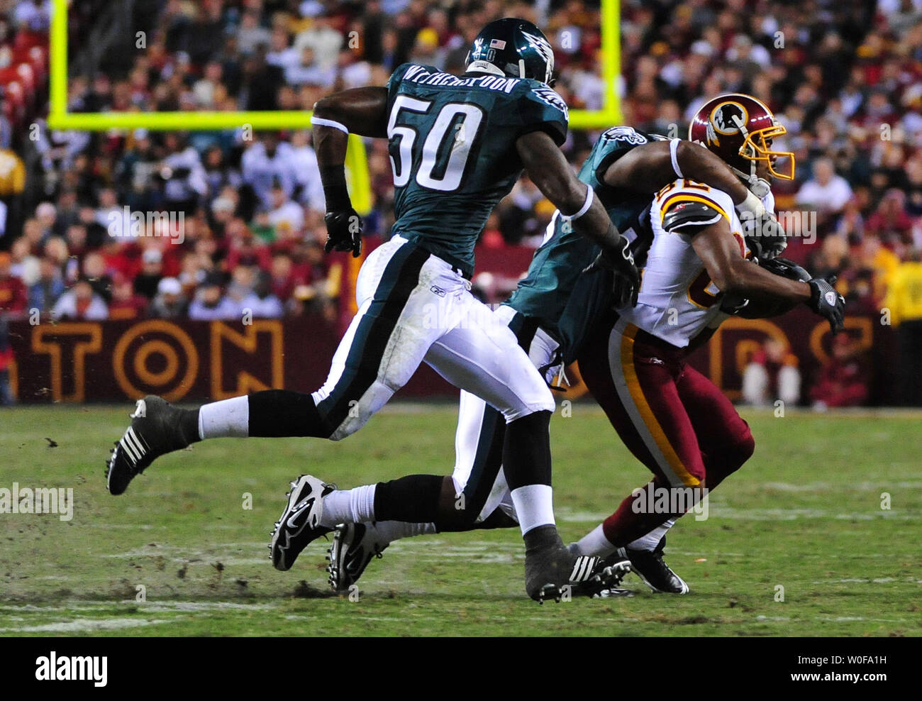 Washington Redskins' Antwaan Randle El is pulled down by the Philadelphia Eagles' defense after a gain of 1-yard during the second quarter at FedEx Field in Landover, Maryland on October 26, 2009.    UPI/Kevin Dietsch Stock Photo