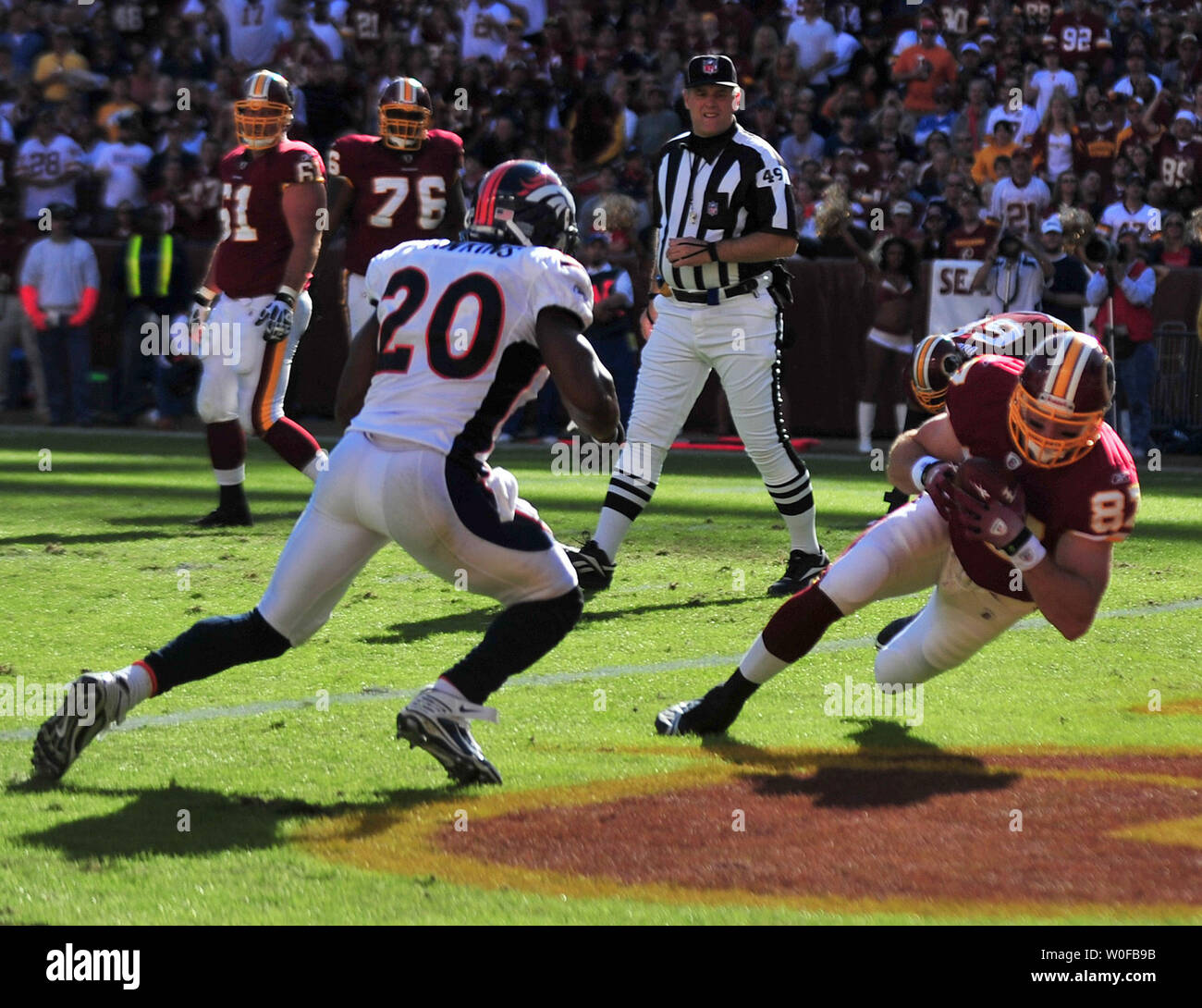 Washington Redskins Todd Yoder (87) brings in a 2-yard touchdwon reception against Denver Broncos' Brian Dawkins (20) during the first quarter at FedEx Field in Landover, Maryland on November 15, 2009.   UPI/Kevin Dietsch Stock Photo