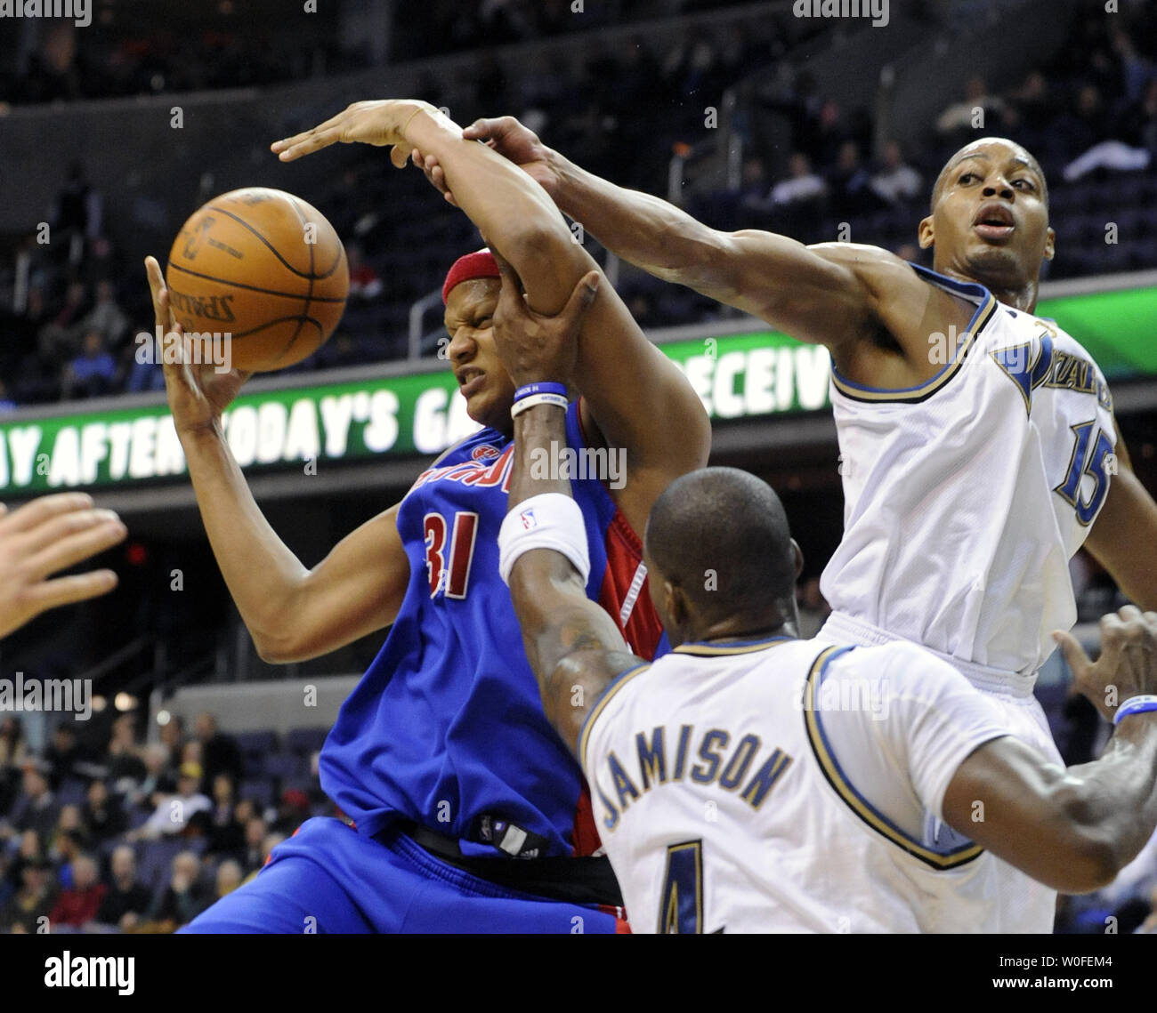 Detroit Pistons Charlie Villanueva (31) is fouled by Washington Wizards Antawn Jamison (4) and Randy Foye (15) during the first period at the Verizon Center in Washington on January 12, 2010. UPI/Alexis C. Glenn Stock Photo