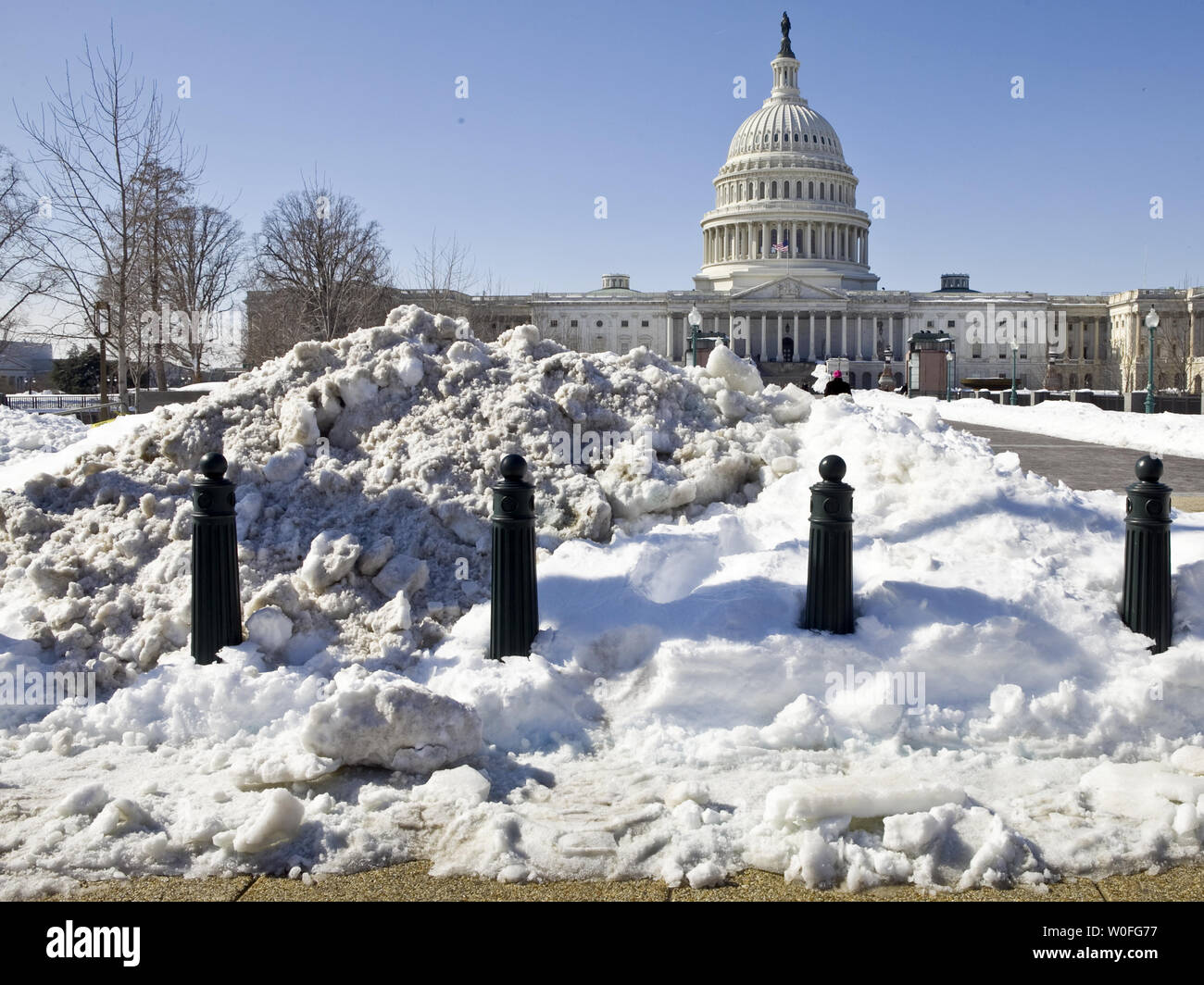 A large mound of snow is seen in front of the U.S. Capitol building