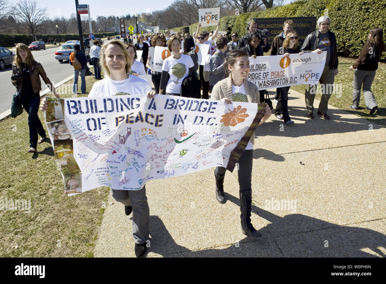 Demonstrators Carry Signs While Marching Towards The Memorial