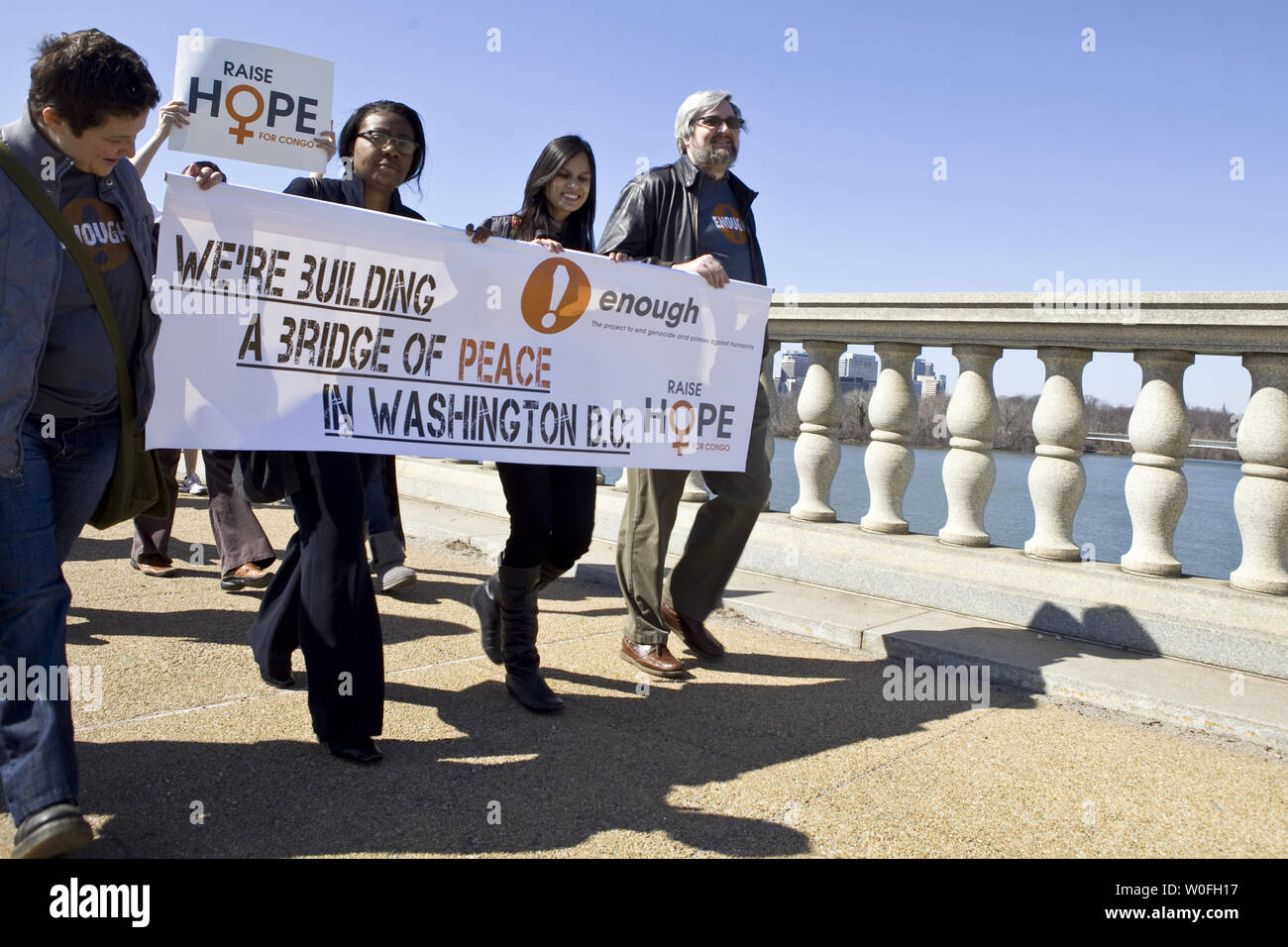 Demonstrators Carry Signs While Marching On The Memorial Bridge