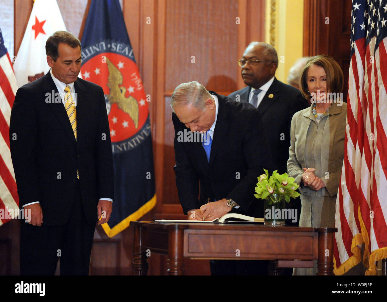 Israeli Prime Minister Benjamin Netanyahu signs a guest book as House Minority Leader John Boehner, R-OH, House Majority Whip James Clyburn, D-SC, and Speaker of the House Nancy Pelosi, D-CA, (L to R) look on before a photo opportunity near the Speaker's Balcony of the U.S. Capitol in Washington on March 23, 2010.     UPI/Roger L. Wollenberg Stock Photo