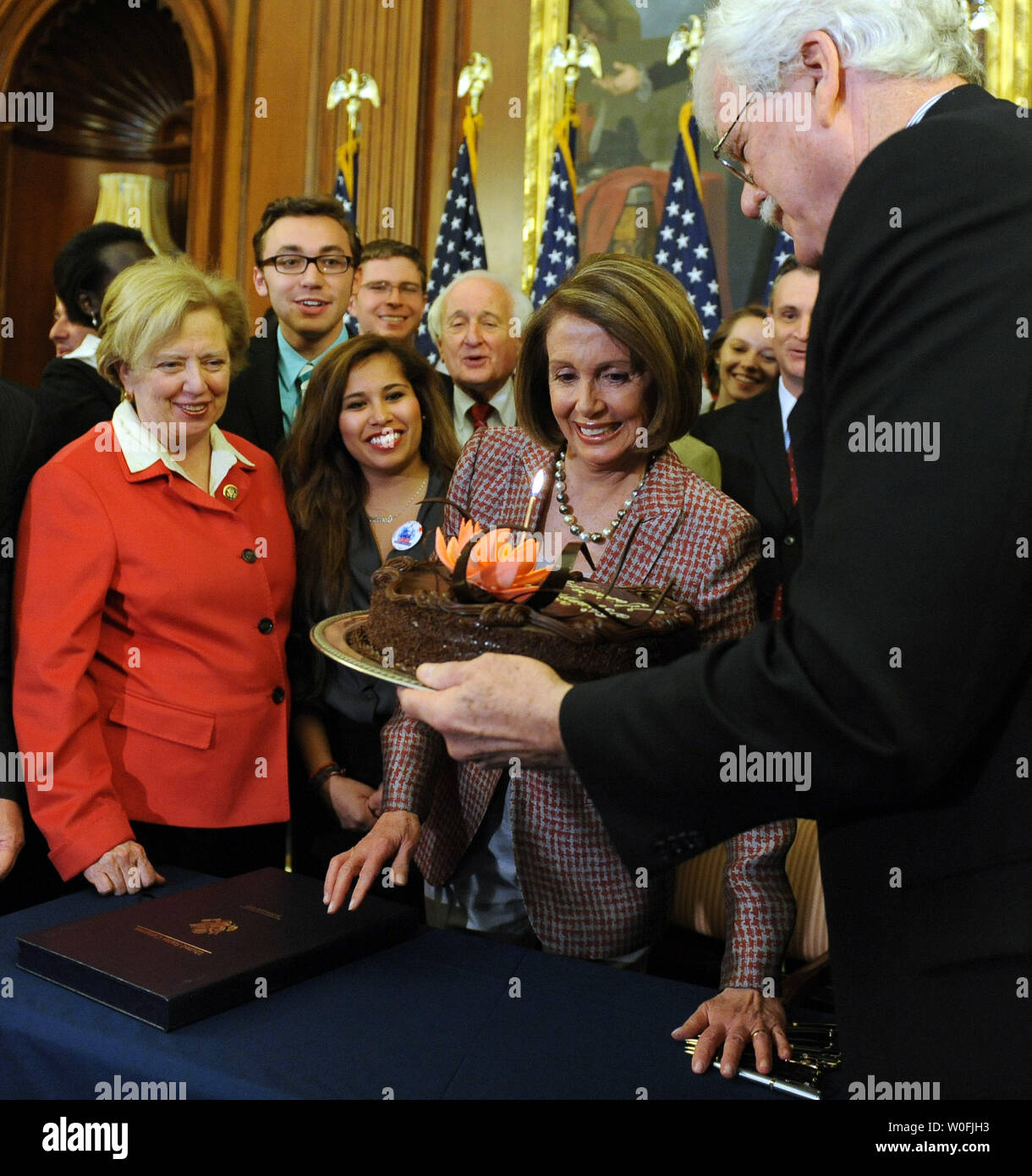 Rep. George Miller, D-CA, brings Speaker of the House Nancy Pelosi, D-CA, a birthday cake after she signed the House Health Care and Education Reconciliation Act after it was passed by the Senate on Capitol Hill in Washington on March 26, 2010. The bill, sometimes referred to as the House 'fix' for the overall health care reform bill passed by the Senate earlier this week, will now go to U.S. President Barack Obama for his signature. Pelosi turned 70 today.   UPI/Roger L. Wollenberg Stock Photo