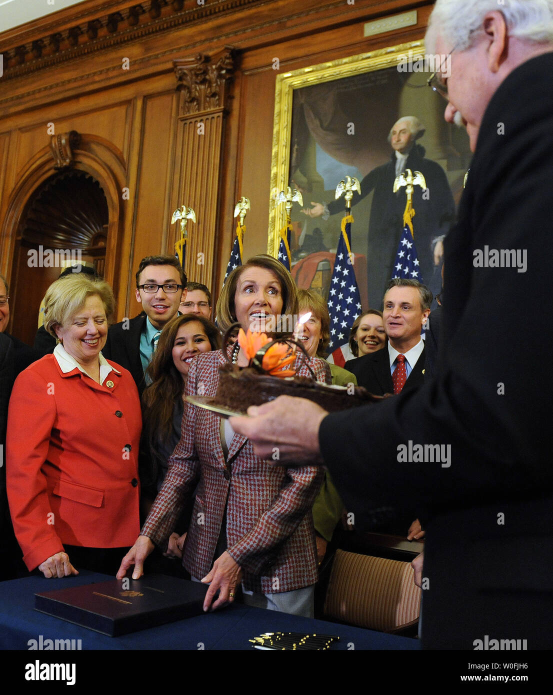 Rep. George Miller, D-CA, brings Speaker of the House Nancy Pelosi, D-CA, a birthday cake after she signed the House Health Care and Education Reconciliation Act after it was passed by the Senate on Capitol Hill in Washington on March 26, 2010. The bill, sometimes referred to as the House 'fix' for the overall health care reform bill passed by the Senate earlier this week, will now go to U.S. President Barack Obama for his signature. Pelosi turned 70 today.   UPI/Roger L. Wollenberg Stock Photo